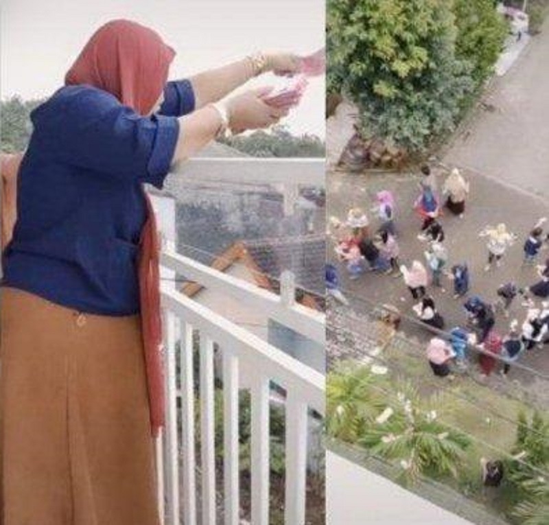Bagi-bagi Rezeki, Wanita Ini Sawer Duit Rp100 Juta dari Balkon Rumahnya